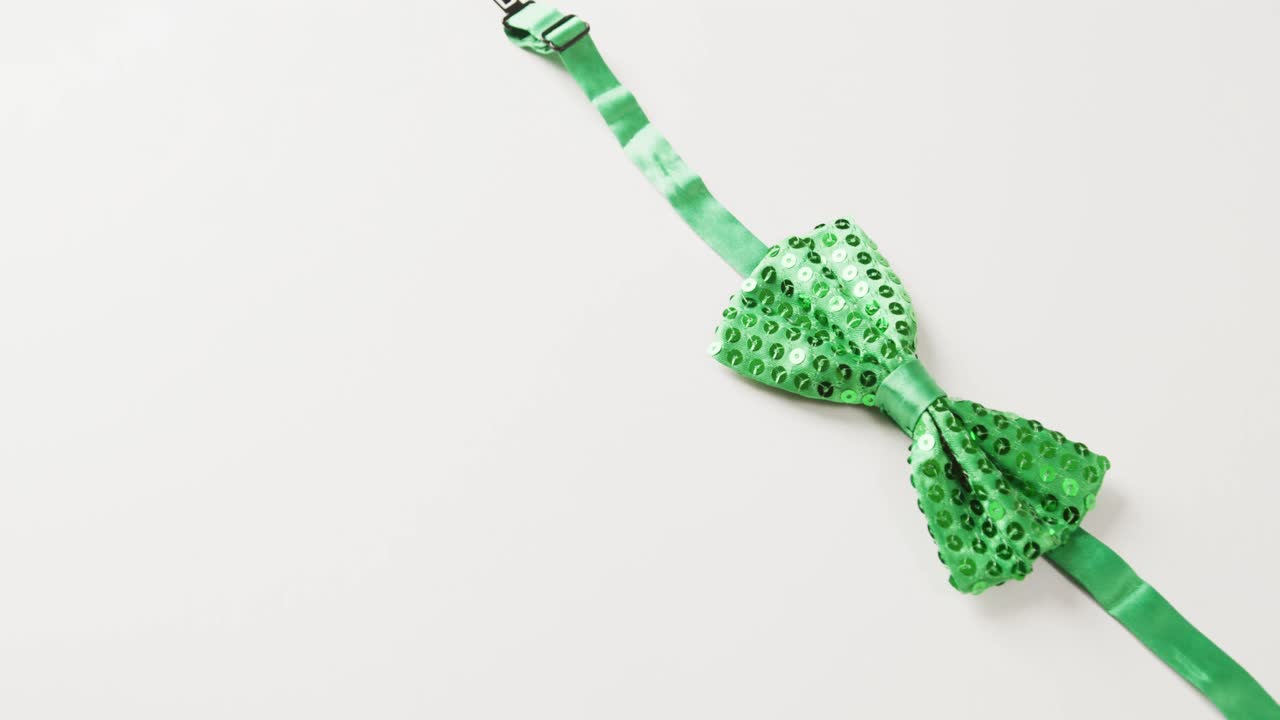 Video of st patrick's green bow tie with copy space on white background