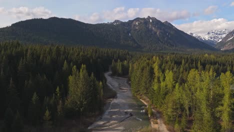 Aerial-forward-moving-view-over-creek-and-Evergreen-forest-at-Gold-Creek-Pond-in-Washington-State