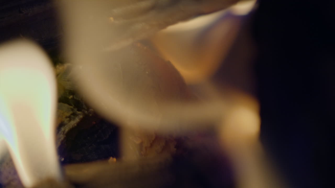 toma a cámara lenta de llamas y brasas en una chimenea