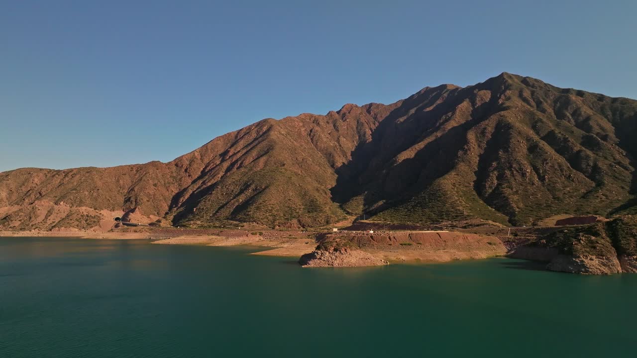 Aerial rotating shot of the uneven mountain terrain at Mendoza during sunset