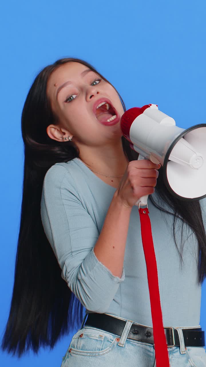 Happy woman talking with megaphone proclaiming news loudly announcing advertisement discounts sale