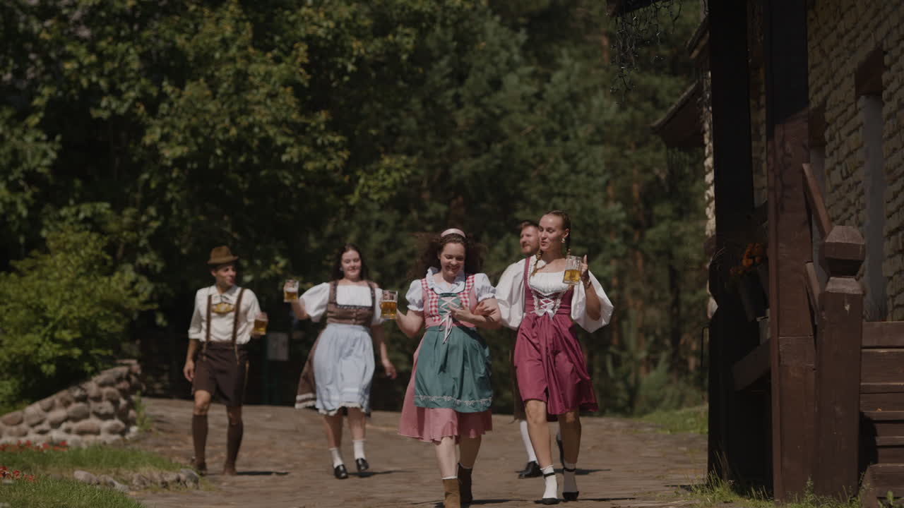 People in traditional Dirndl clothing holding beer glasses