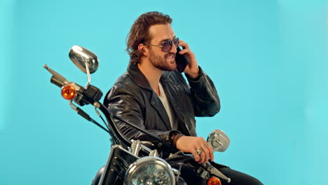 phone call, motorbike and man in studio on blue