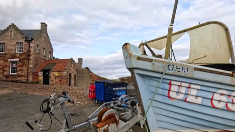 boat docked near historic buildings in crail