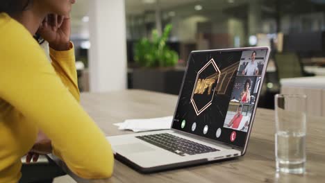 African-american-businesswoman-using-laptop-for-video-call-with-diverse-business-colleagues