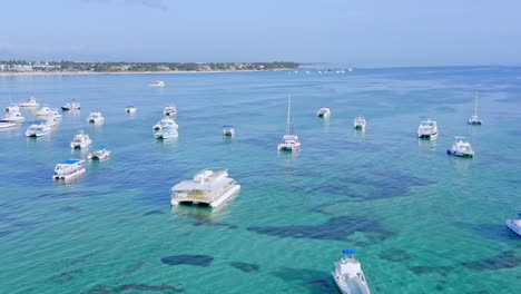 Boats-Floating-On-Shallow-Blue-Sea-In-Summer