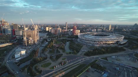 west ham united football stadium with london city landmark venue aerial view pull back across cityscape