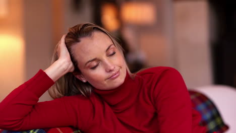 pretty blonde getting a headache on the couch