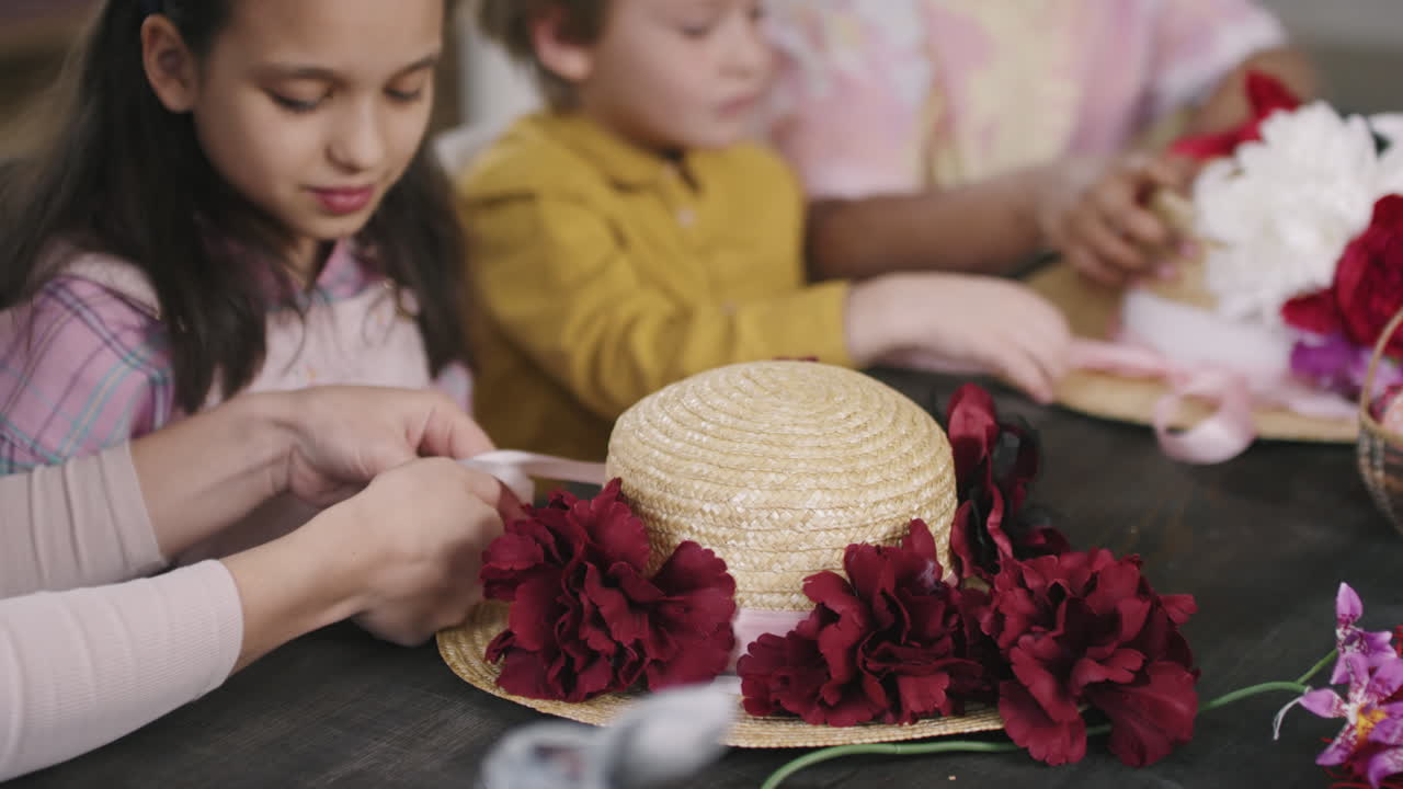 Unrecognizable Teacher Helping Children in Easter Workshop