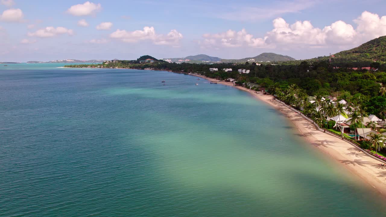 4k Drone Footage of the Beach at Mae Nam on Koh Samui in Thailand, Including Beachfront Resorts with Beautiful Clouds in the Sky and Crystal Teal Water