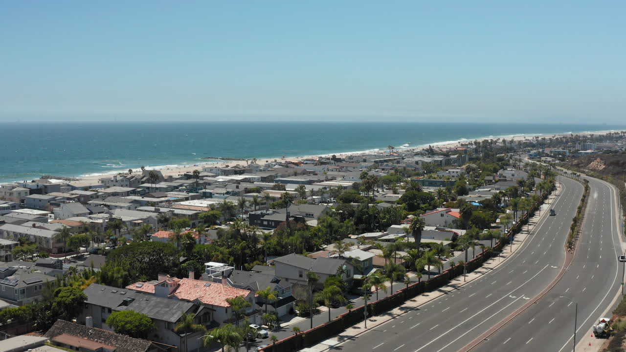 Traffic At Pacific Coast Highway With Seascape In Newport Beach, California, USA. - aerial
