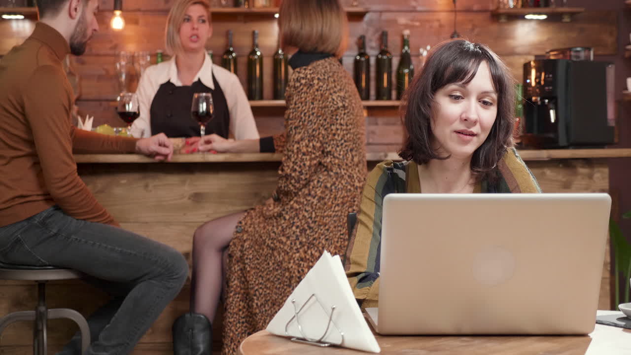 People working and socializing at a bar