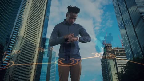 Animation-of-african-american-businessman-using-smartwatch-over-cityscape