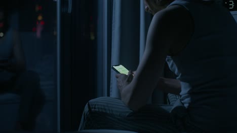 man texting on phone in bed at night