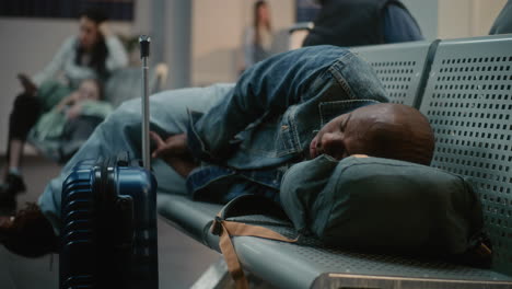 tired traveler sleeping at the airport