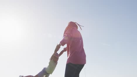 Video-of-happy-african-american-father-and-son-having-fun-on-sunny-day