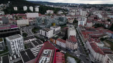 Revealing-drone-shot-of-Saint-Etienne-city-in-Loire-Departement-with-design-building-and-nature