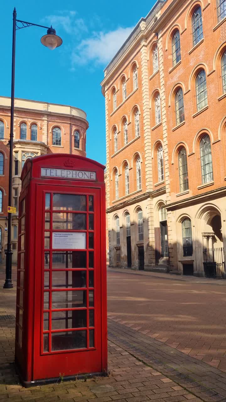 A classic red telephone box stands in Nottingham’s historic Lace Market on Broadway, glowing under the summer sun