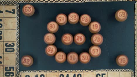 cinematic close-up smooth zoom out, shot from above of a bingo wooden barrels in a circle, woody figures, old numbers background, vintage board game, professional lighting, slow motion 120 fps