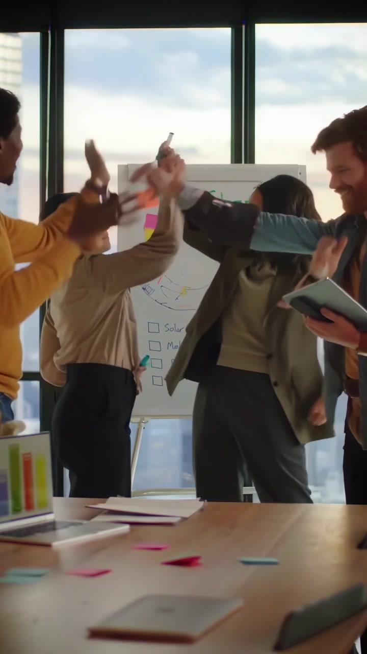 Diverse Business Team Collaborating on Eco-Friendly Project in Modern Office