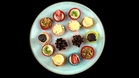 mini fruit tarts on the turning blue plate