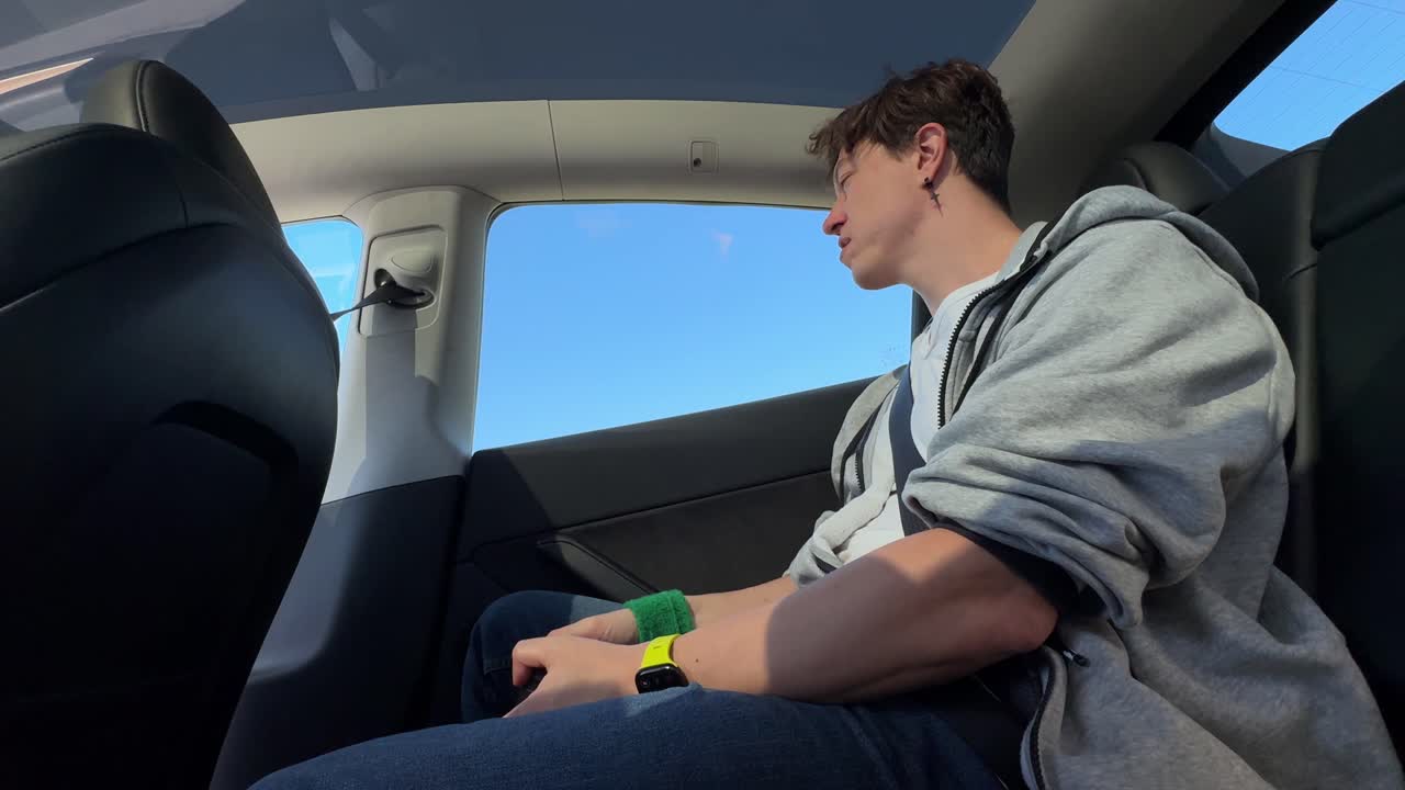 Person sitting in the back seat of a car