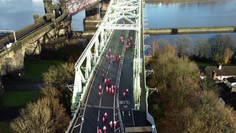 charity santa dash fun run over runcorn silver jubilee bridge aerial view rising forwards