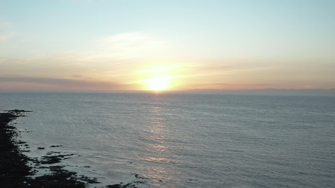 Sunset at tourist destination lighthouse Garðskagaviti on Iceland shore