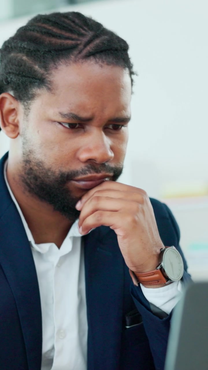 Focused Businessman Working on Laptop in Office
