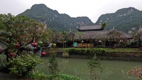 peaceful river view with traditional architecture and mountains