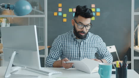 man working at his computer in an office