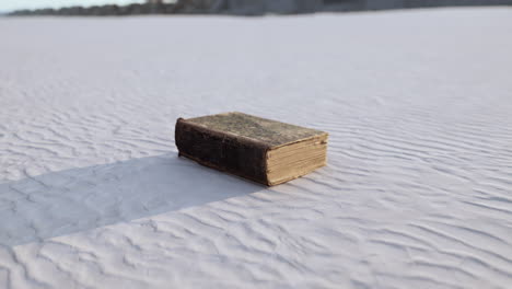 old-book-on-the-sand-beach