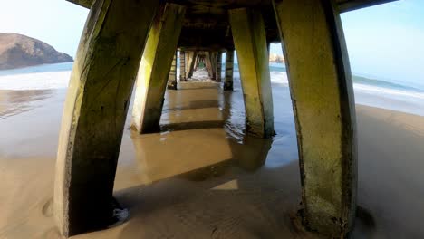 Go-pro-video-of-walking-under-a-pier-in-Lima,-Peru