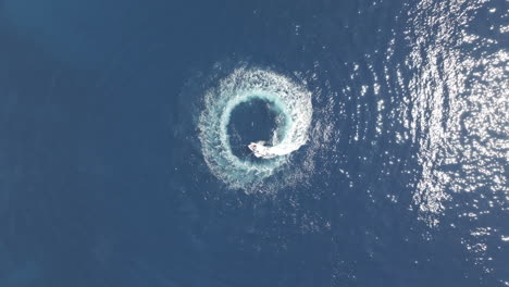 Motorboat-Spinning-in-Circles-in-Blue-Sea-Water