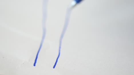 blue pen writing on paper