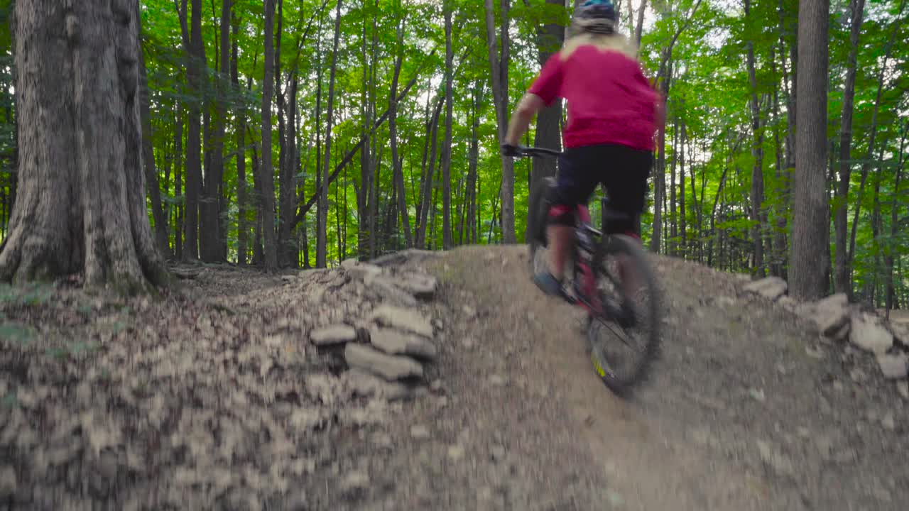 A rider hits a jump and throws a nasty whip.