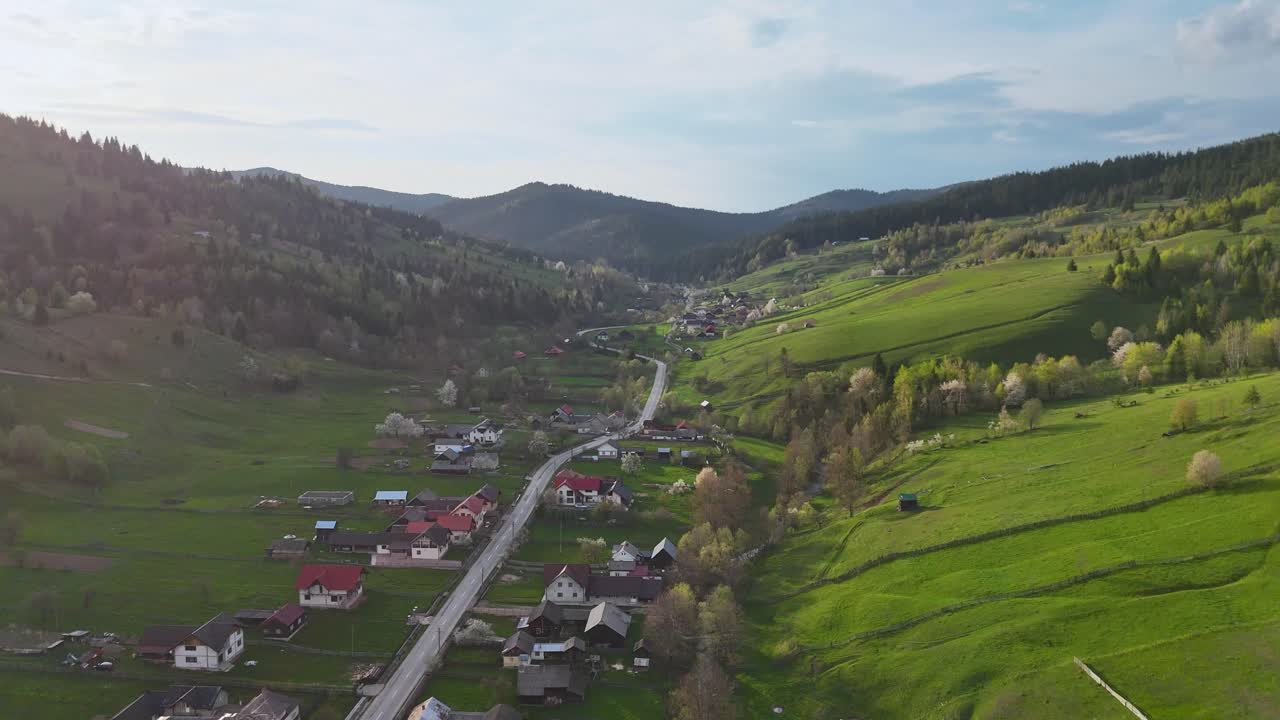 Romanian village with winding road and green surroundings