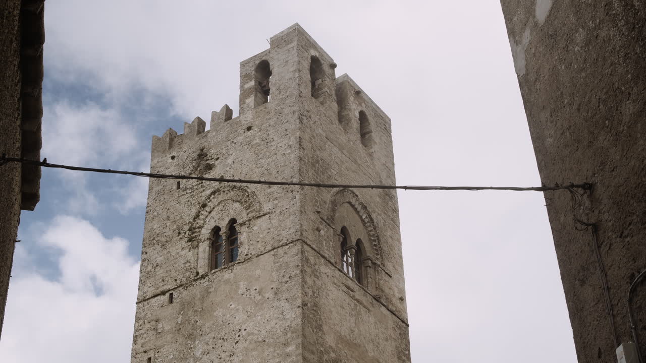 Ancient Stone Tower in a Narrow Alley
