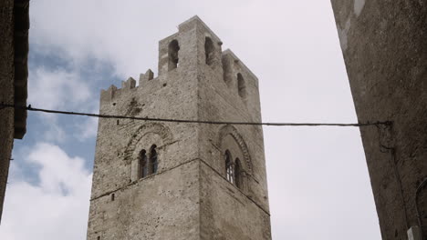 ancient stone tower in a narrow alley