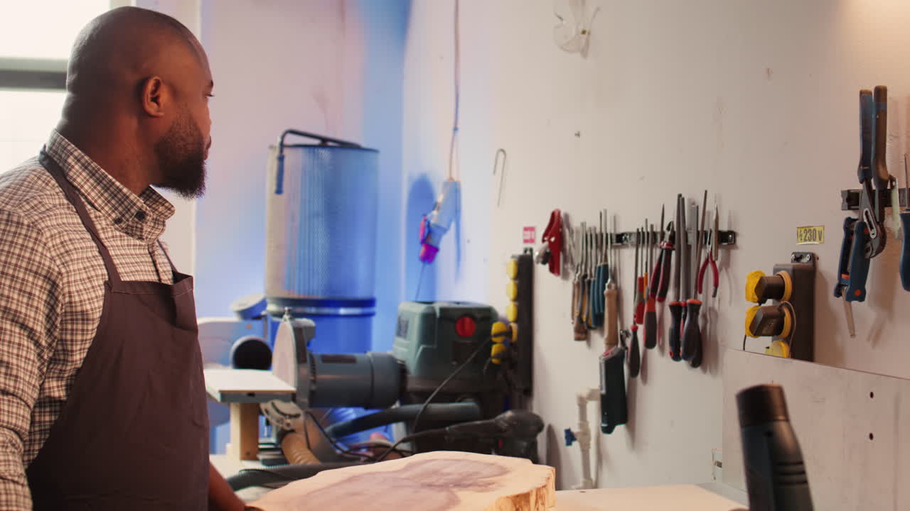 Cabinetmaker picking lumber block, preparing to do piling on it