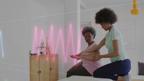 animation of cardiographs over senior biracial woman exercising with female physiotherapist