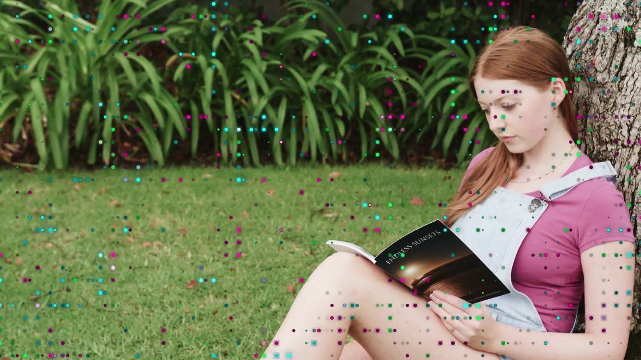 Adult woman sitting by tree, camera panning while turning pages for study, dot overlay covering her