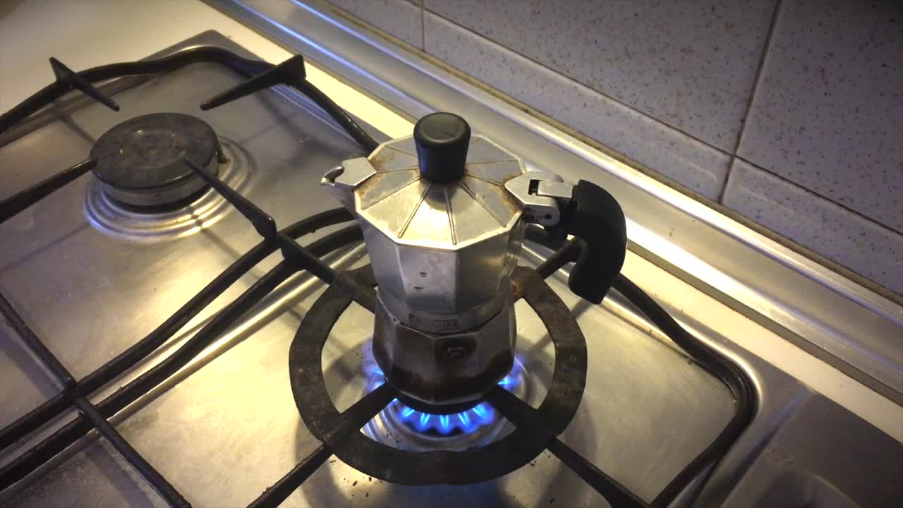 Opening Lid of Moka Pot on Stovetop