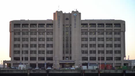 imposing view of a large industrial building at dusk with a clear sky, showcasing architectural details and urban elements, symbolizing modern industry and functionality