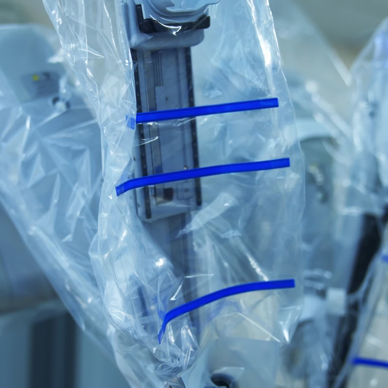 Futuristic robotic equipment at operational room. Da Vinci robotic arms coated with plastic and no devices connected. Close up