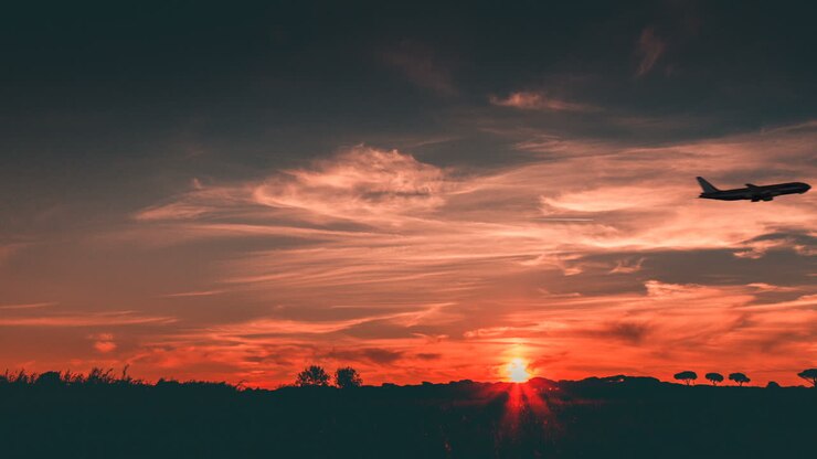 Airplane Take Off at Sunset with Orange Sky