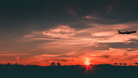 airplane take off at sunset with orange sky