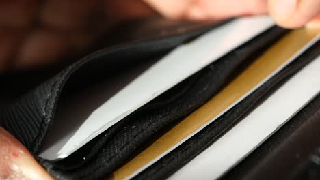 close-up of a black wallet with credit cards inside