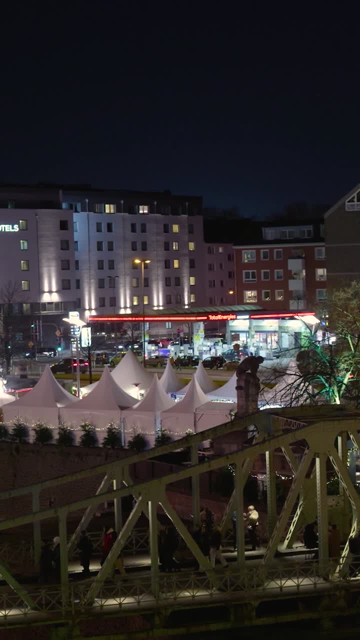 Nighttime Cityscape with Christmas Market and Lit Buildings