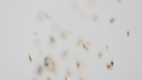 barley and grains being tossed into the air on a white background three times